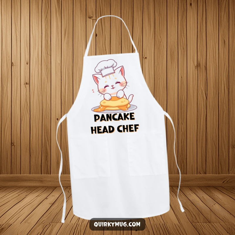 Funny cat chef apron, cute cat wearing a tiny chef hat, with a pancake landed on its head.