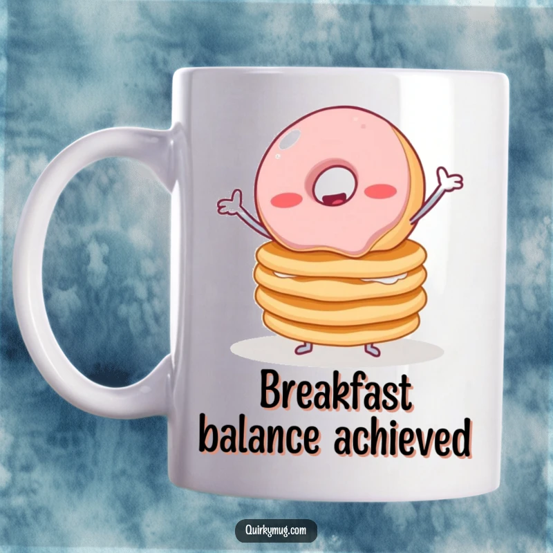 Funny mug depicting a cute, wobbly jelly donut with tiny arms struggling to balance a towering stack of pancakes, showcasing breakfast chaos.