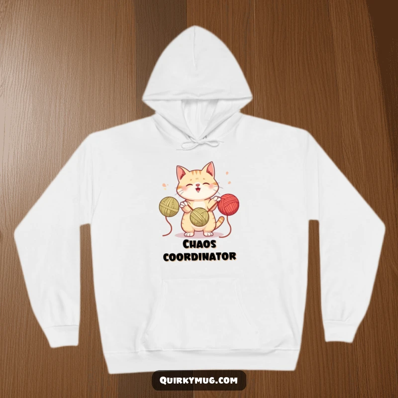 Funny hoodie with a mischievous cat attempting to juggle three yarn balls, combining warmth with feline-themed humor.