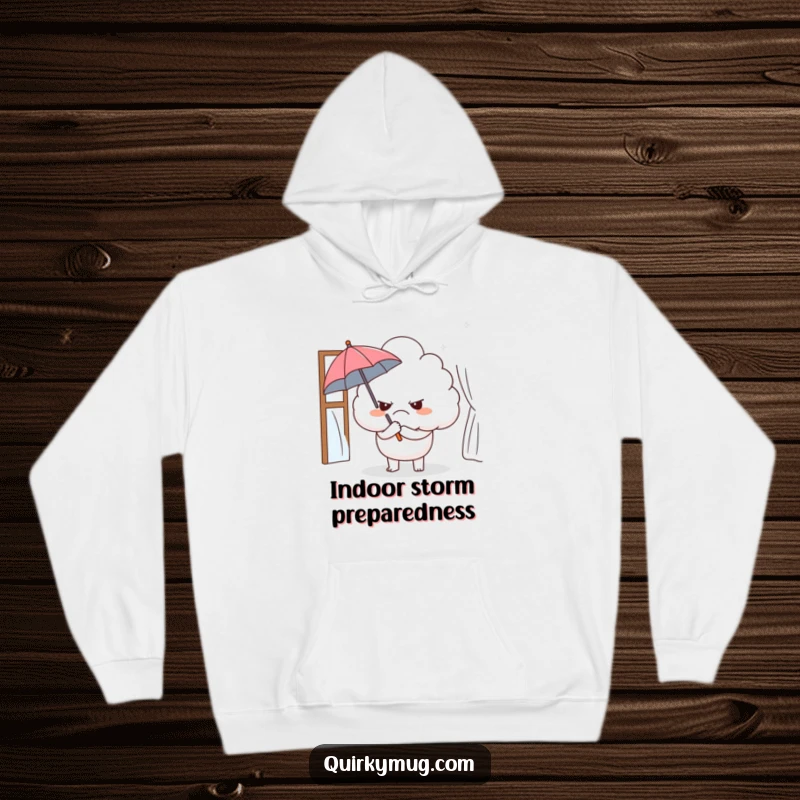 Funny hoodie with a grumpy cloud character holding a small umbrella indoors, embodying relatable irony and cozy comfort.