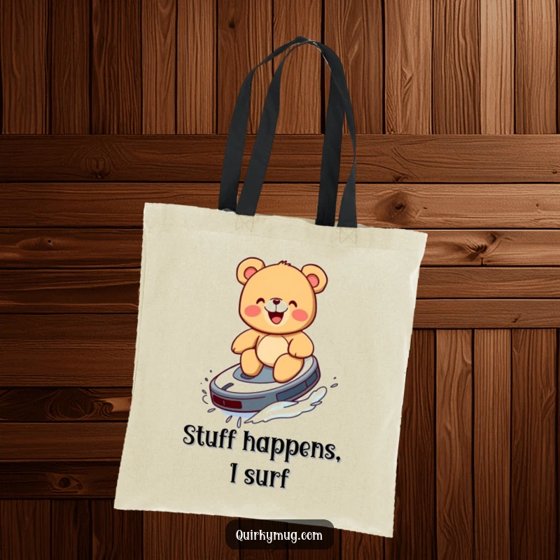 Funny tote bag showing a giggling teddy bear riding a Roomba like a surfboard.